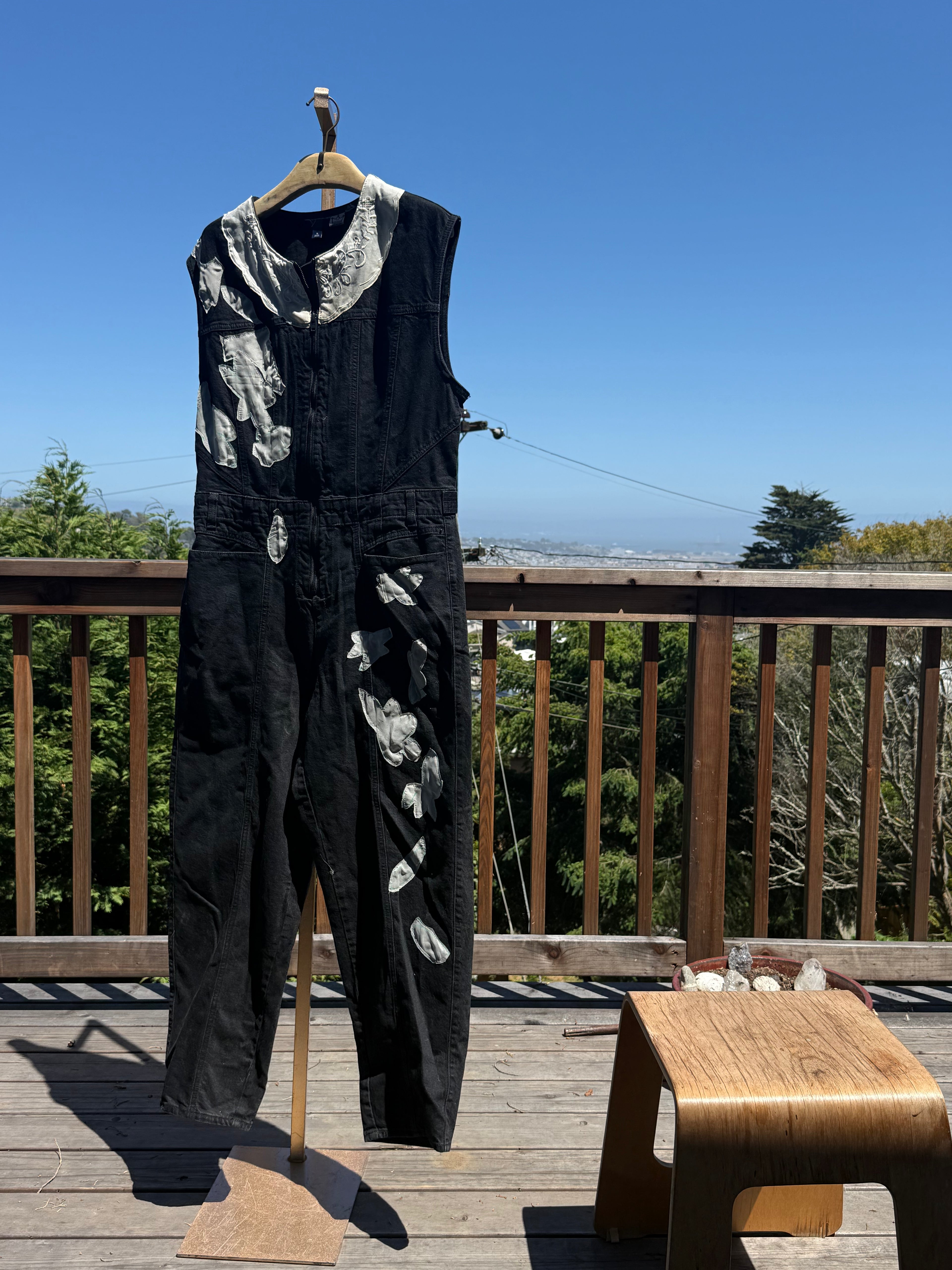 Black sleeveless denim jumpsuit with lace and Barong Tagalog accents