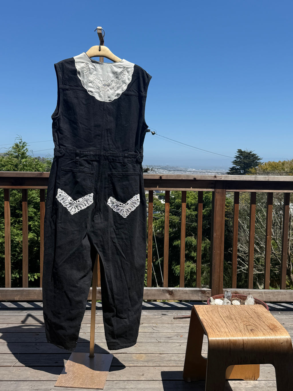 Black sleeveless denim jumpsuit with lace and Barong Tagalog accents