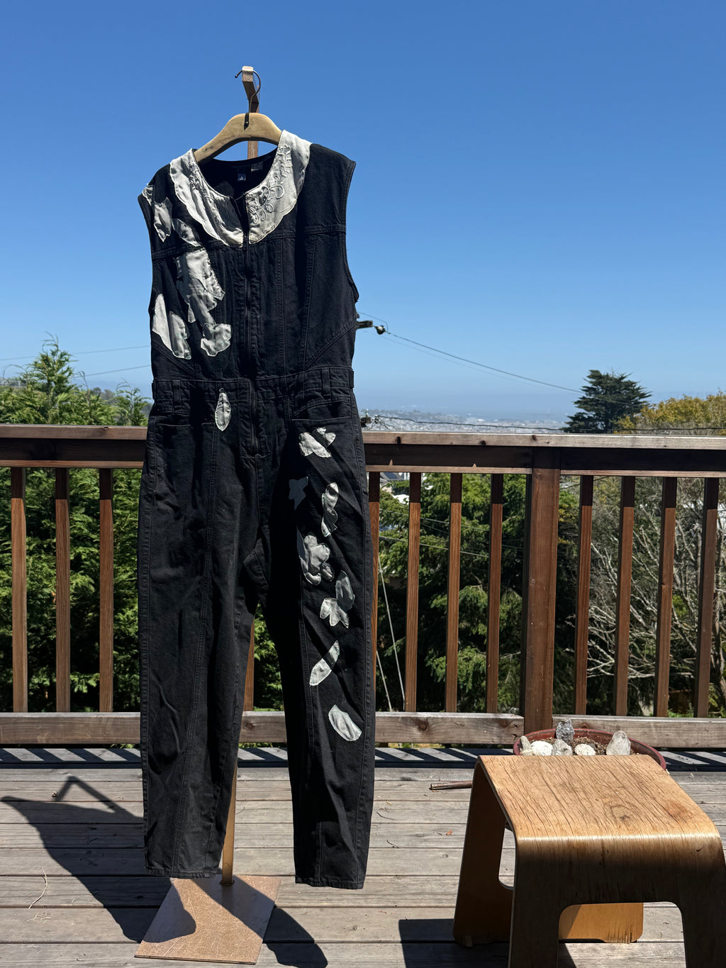 Black sleeveless denim jumpsuit with lace and Barong Tagalog accents