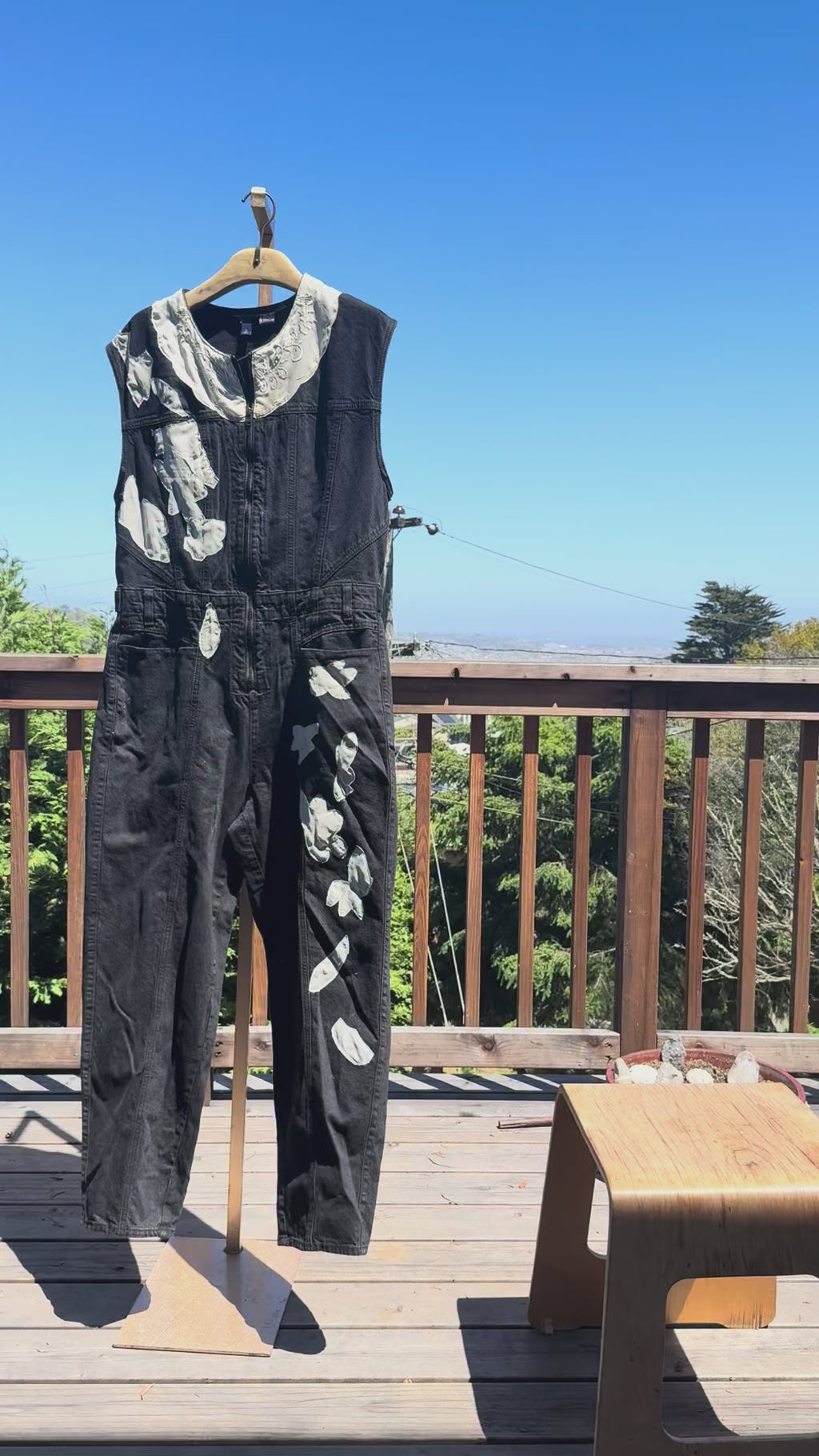 Black sleeveless denim jumpsuit with lace and Barong Tagalog accents